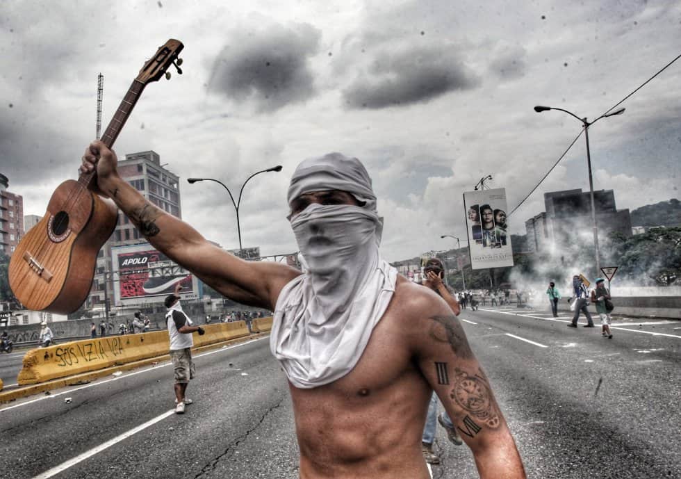 Опозиционен демонстрант и певец–героизиран и от снимката. Източник: Ел Паис
