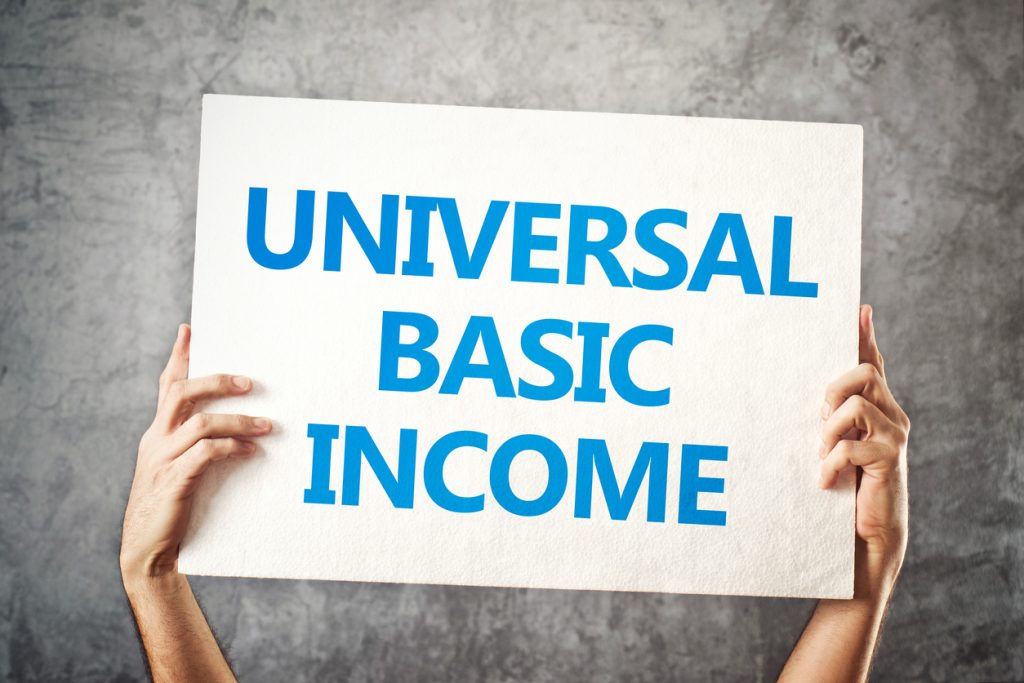 Universal basic income concept with hands holding banner