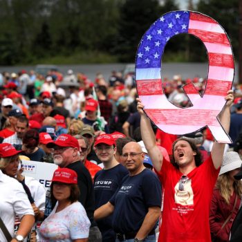 WILKES BARRE, PA - AUGUST 02: David Reinert holds up a large "Q" sign while waiting in line to see President Donald J. Trump at his rally on August 2, 2018 at the Mohegan Sun Arena at Casey Plaza in Wilkes Barre, Pennsylvania. "Q" represents QAnon, a conspiracy theory group that has been seen at recent rallies. (Photo by Rick Loomis/Getty Images)