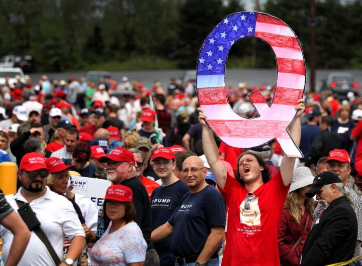 WILKES BARRE, PA - AUGUST 02: David Reinert holds up a large "Q" sign while waiting in line to see President Donald J. Trump at his rally on August 2, 2018 at the Mohegan Sun Arena at Casey Plaza in Wilkes Barre, Pennsylvania. "Q" represents QAnon, a conspiracy theory group that has been seen at recent rallies. (Photo by Rick Loomis/Getty Images)