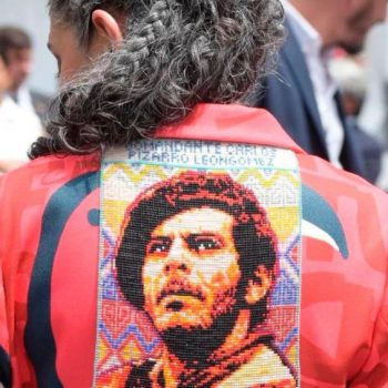 Мария Хосе Писаро бе облечена в дълго сако с портрет на баща си Карлос Писарона гърба. Снимка: resumenlatinoamericano.org