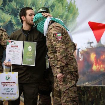 on February 22, 2025, shows newly-released Israeli hostage Omer Shem Tov kissing the head of a Hamas fighter shortly after being set free in Nuseirat in the central Gaza Strip