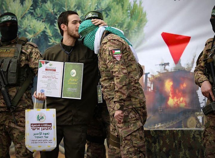 on February 22, 2025, shows newly-released Israeli hostage Omer Shem Tov kissing the head of a Hamas fighter shortly after being set free in Nuseirat in the central Gaza Strip